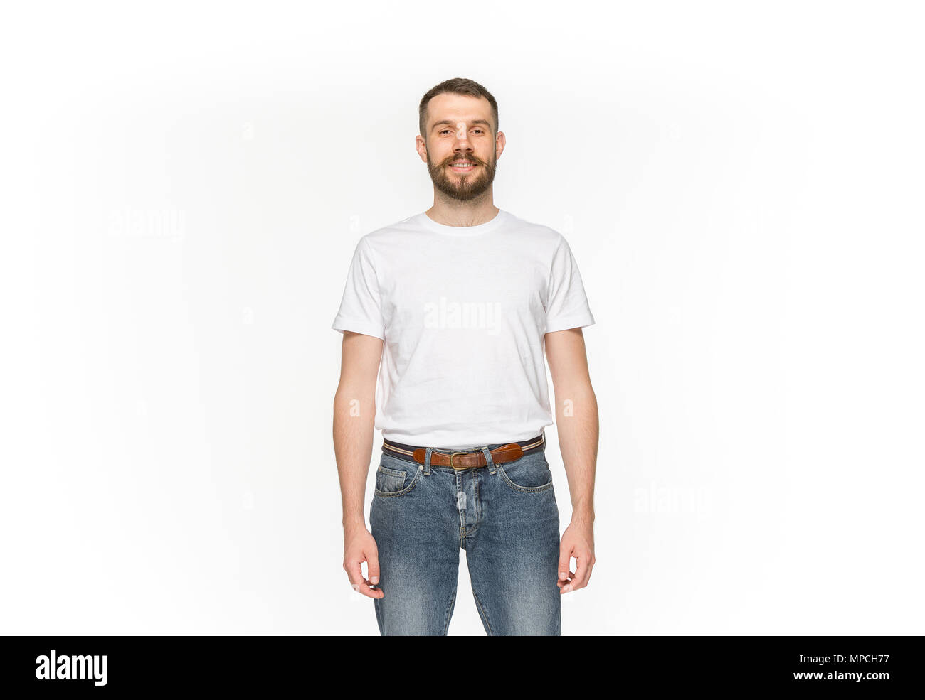 Closeup of young man's body in empty white t-shirt isolated on white background. Mock up for disign concept Stock Photo