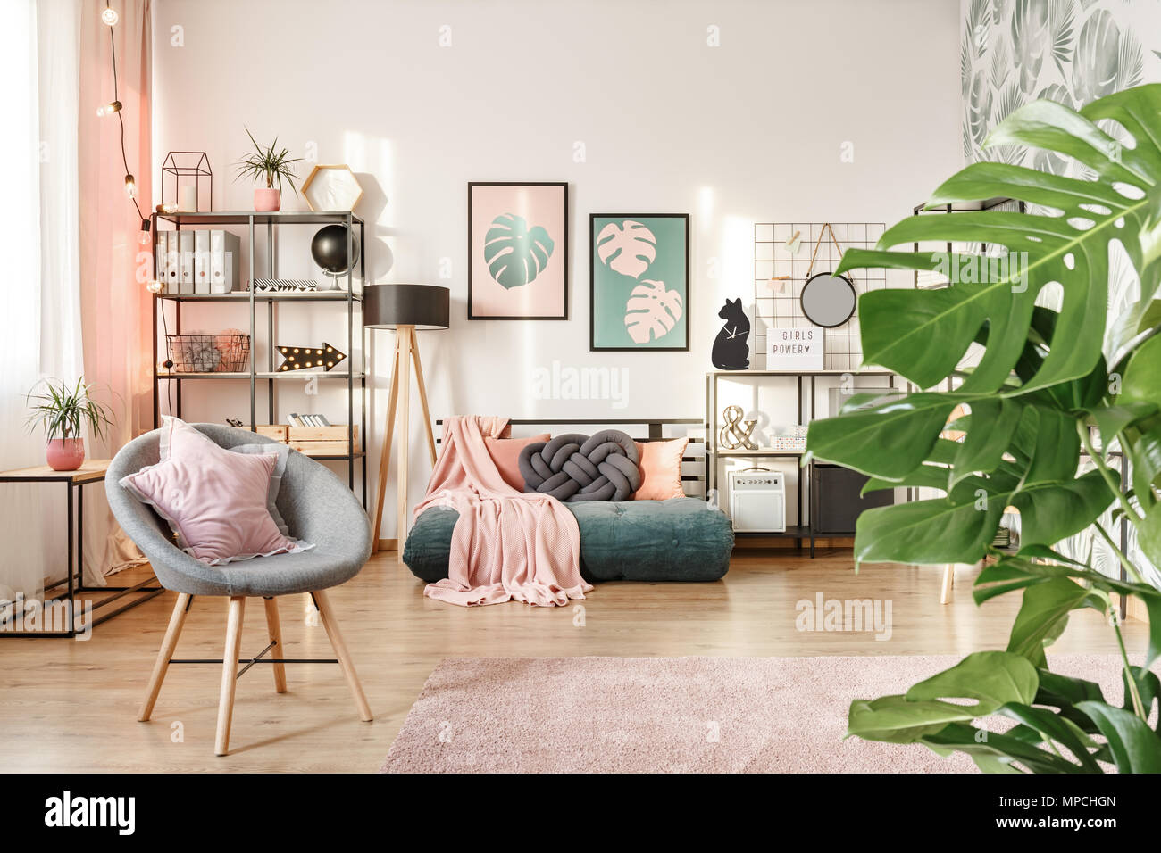 Closeup of leaves, grey armchair with a star pillow and green mattress