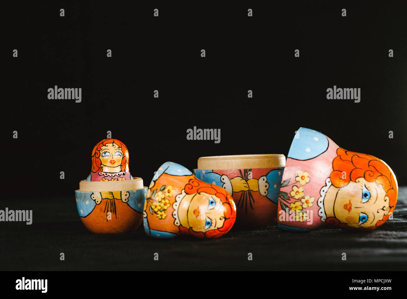 Russian nesting doll stands on a black background Stock Photo - Alamy