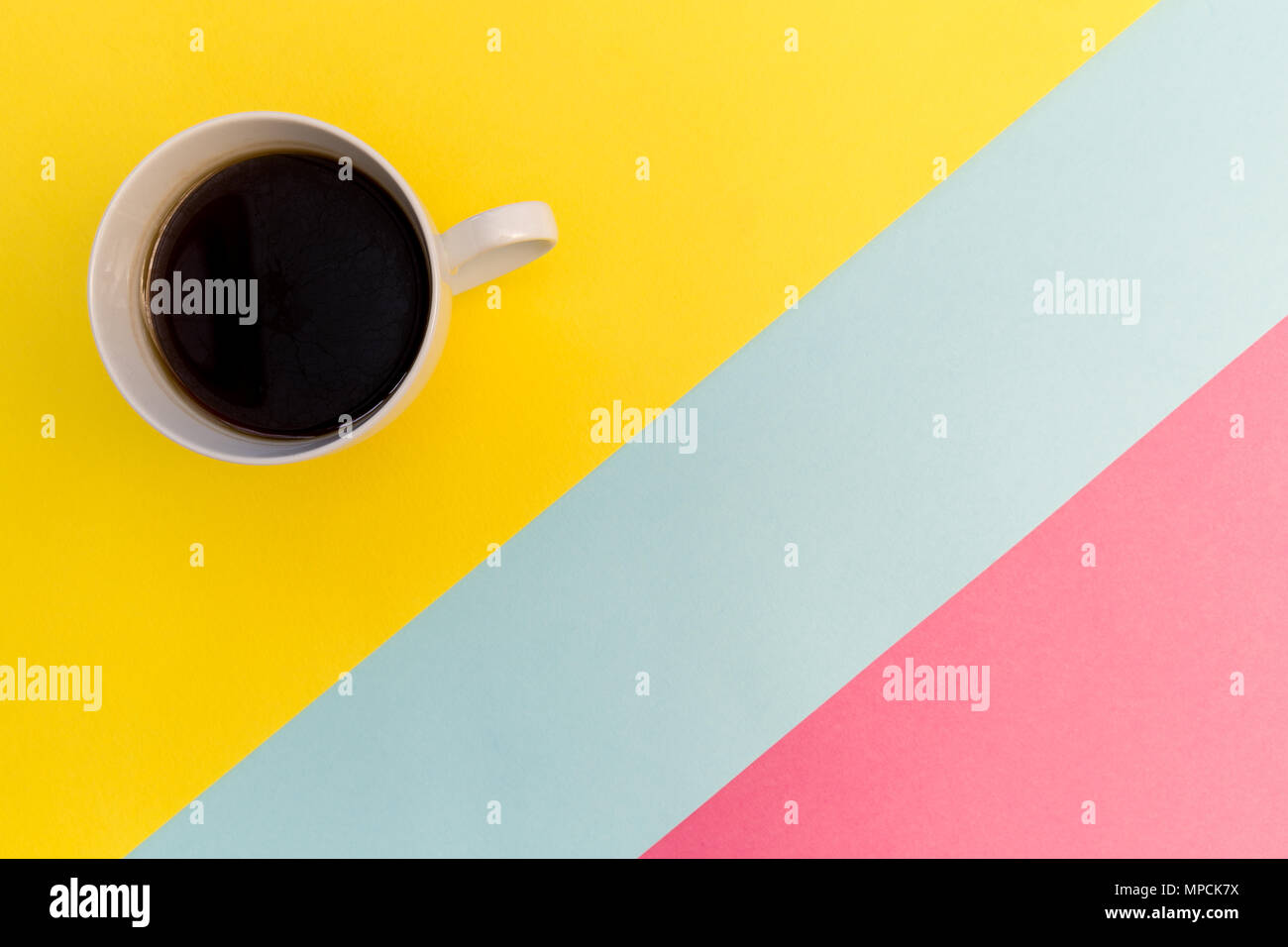 Coffee cup on bright minimal yellow background Stock Photo