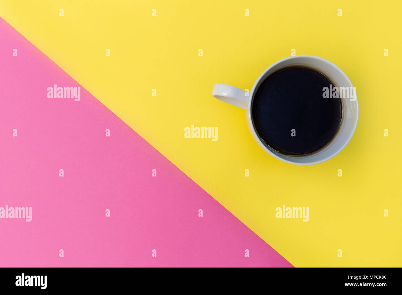 Coffee cup on bright minimal yellow background Stock Photo