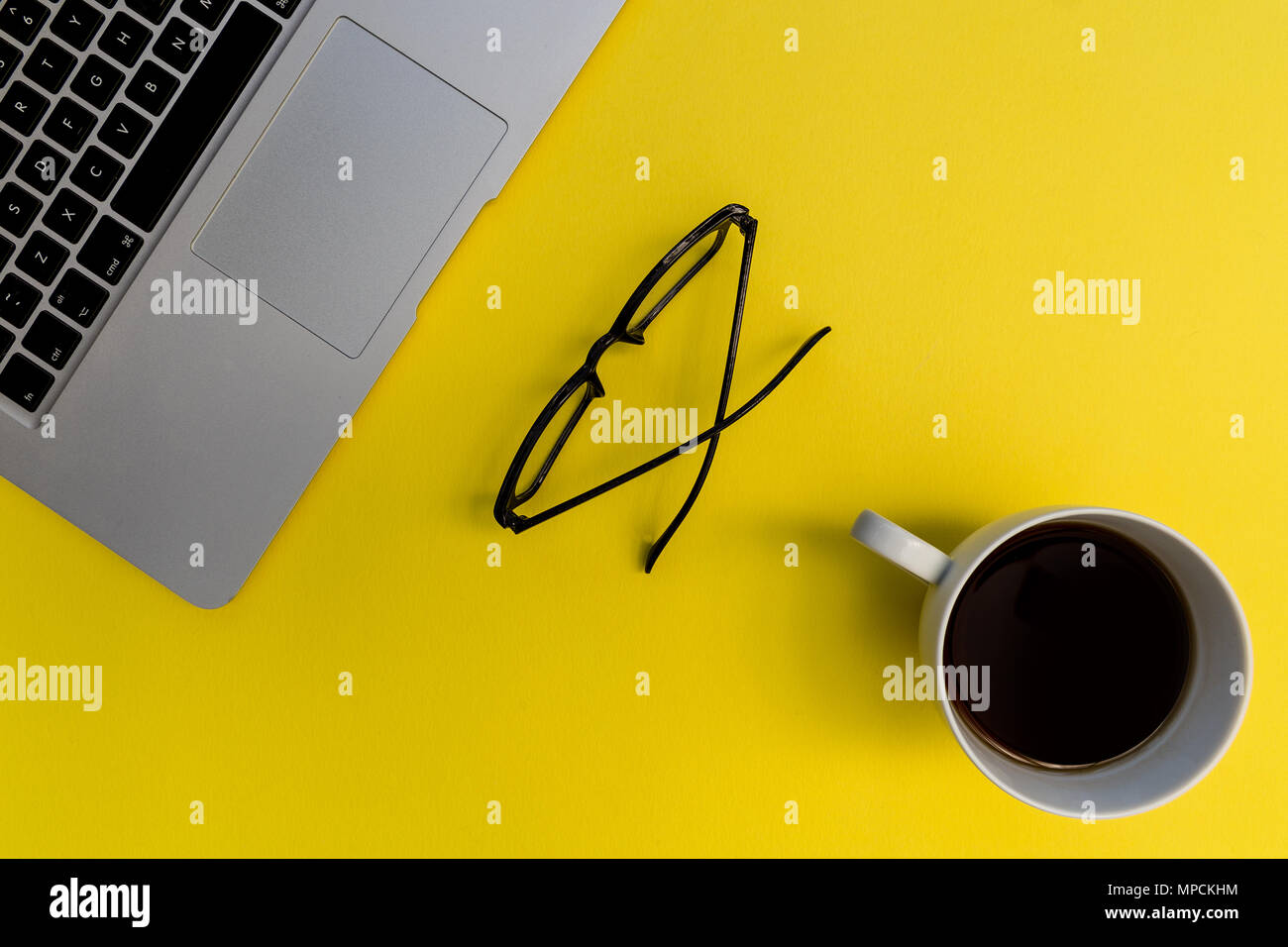 Laptop computer notebook on bright yellow background Stock Photo