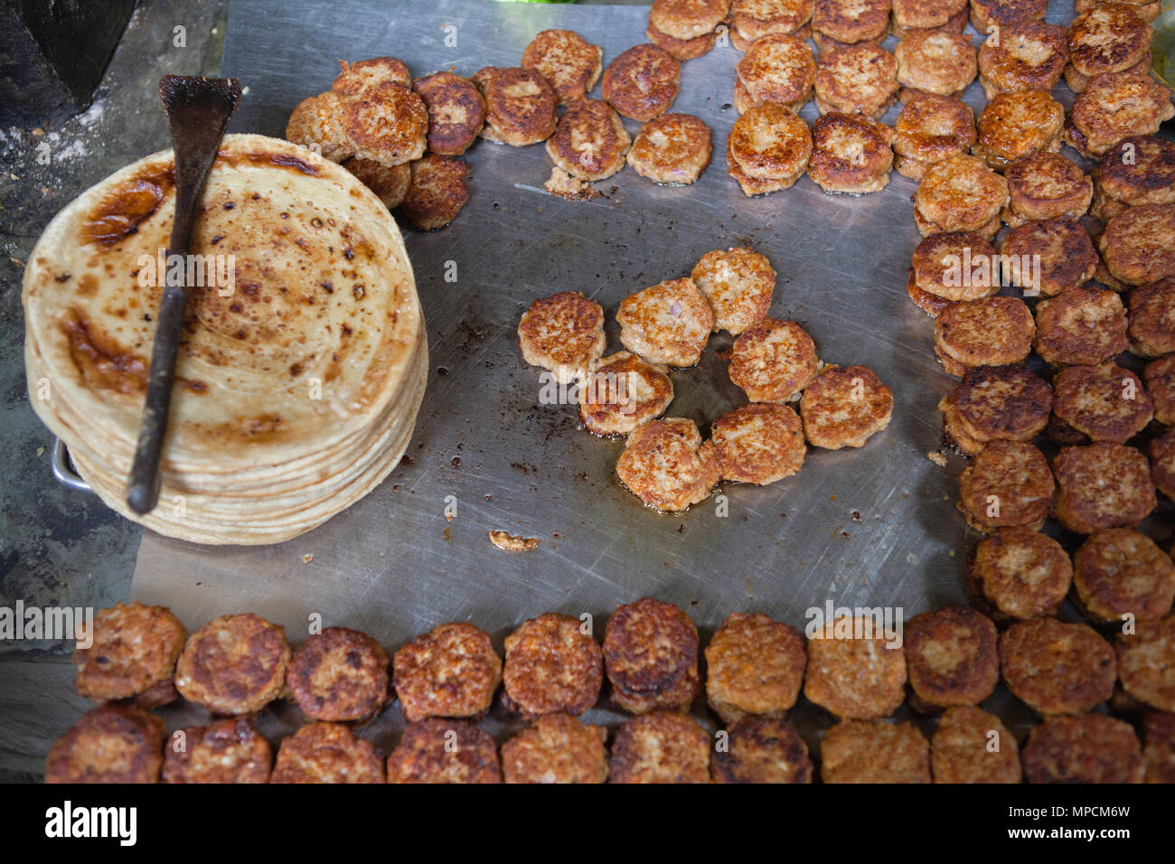 India, Uttar Pradesh, Faizabad, Display of cooked parathas and mutton