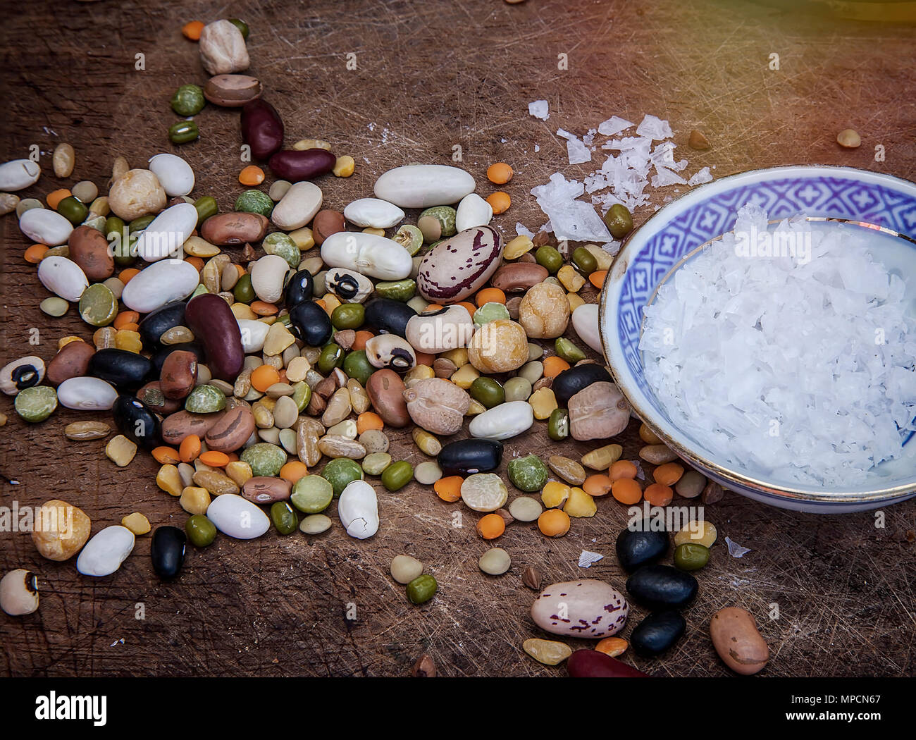 Colourful Dried Beans on a wooden surface with crystal salt. Isolated. Stock Image. Stock Photo