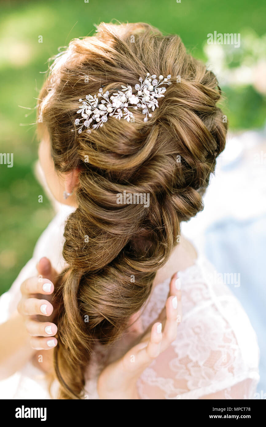 style femininity bride s hairstyle concepr. in soft curly light brown hair of young woman there is shining barrette with diamonds in form of leaves Stock Photo Alamy