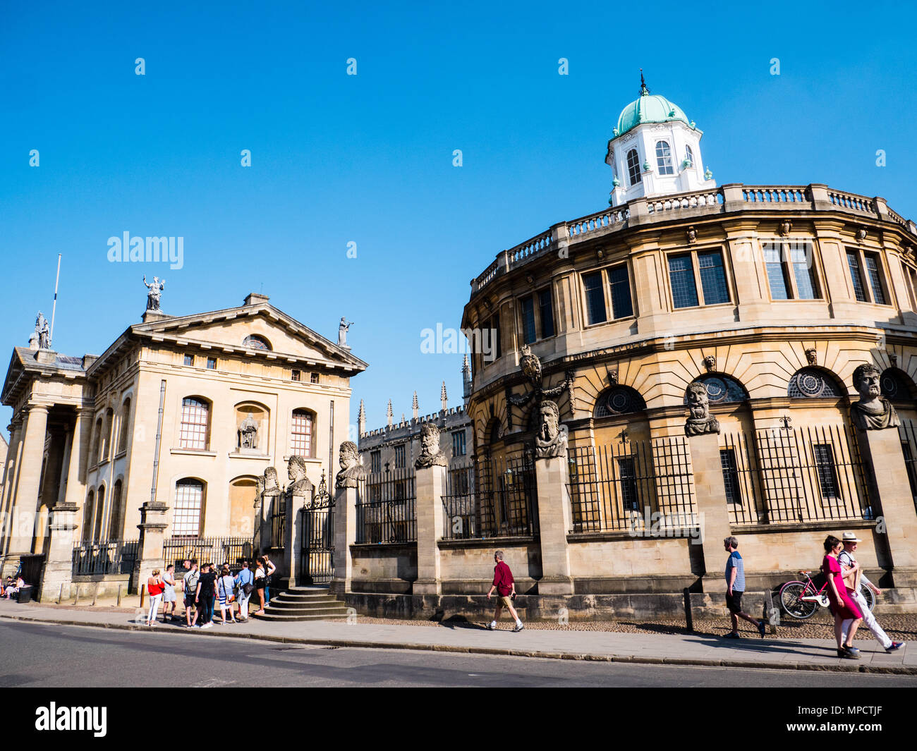 Tourists outside, Clarendon Building, and The Sheldonian Theatre, University of Oxford, Oxfordshire, UK, England, UK, GB. Stock Photo