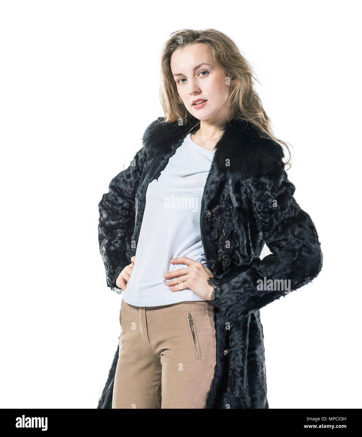portrait of young business woman in a black coat on a white background ...