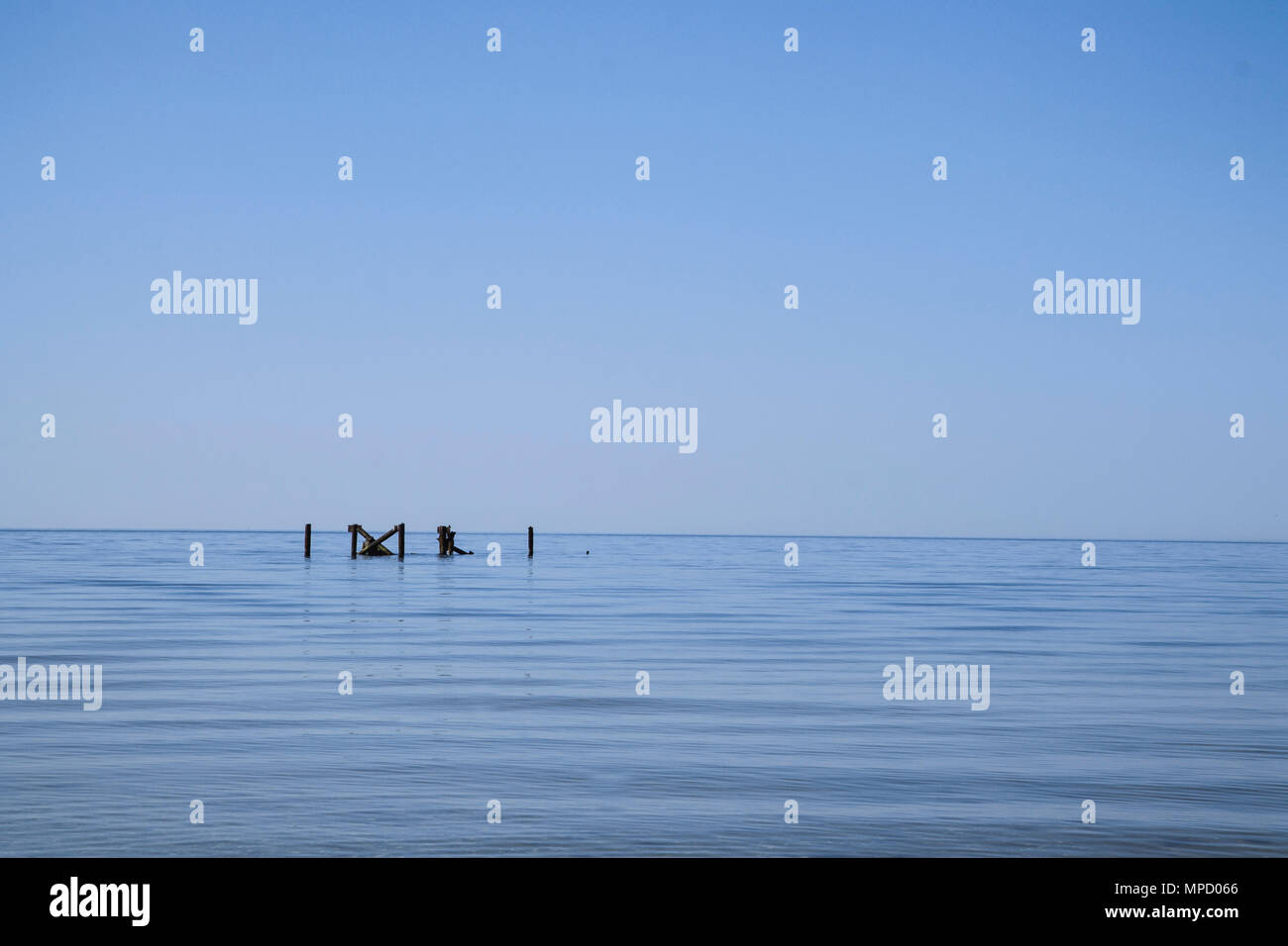 Blue sea. Blue sky. Some architectural objects in the water. Calm and minimalism composition Stock Photo