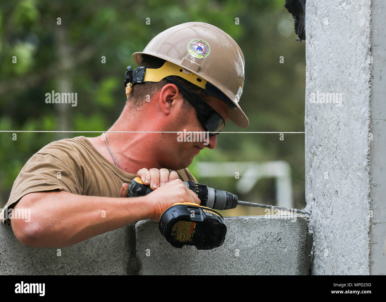 U.S. Navy Seaman Brandon Kase, a builder with Naval Mobile Construction Battalion Five and Chicago native, drills a hole during the construction of a classroom at Ban Nong Muong School, Rayong Province, Thailand, during exercise Cobra Gold, Feb. 2, 2017. Cobra Gold, in its 36th iteration, focuses on humanitarian civic action, community engagement, and medical activities to support the needs and humanitarian interest of civilian populations around the region. (U.S. Marine Corps photo by Cpl. Wesley Timm) Stock Photo