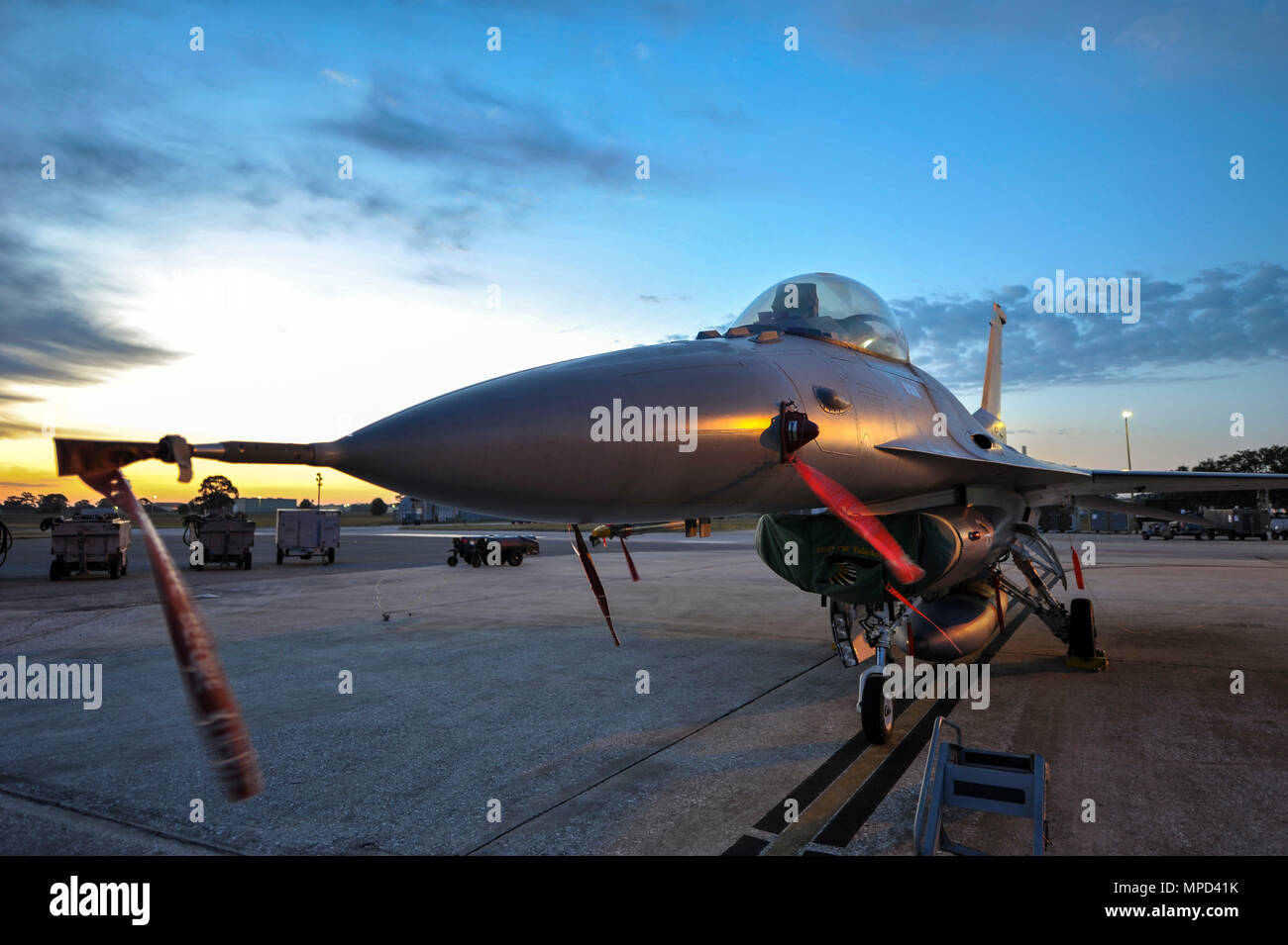 An F-16 Fighting Falcon from the 180th Fighter Wing in Swanton, Ohio stands ready and waiting in the early morning hours for the day’s training exercises to begin at MacDill Air Force Base in Tampa, Fla., on Feb. 2, 2017. The 180FW brought F-16s and more than 150 maintainers, pilots, and operations support personnel to MacDill for a two week training exercise which included basic fighter maneuvers against F-18 Hornets from the Canadian 425th Tactical Fighter Squadron, sharpening the combat capabilities of the 180FW Airmen. (U.S. Air National Guard photo by Tech. Sgt. Nic Kuetemeyer) Stock Photo