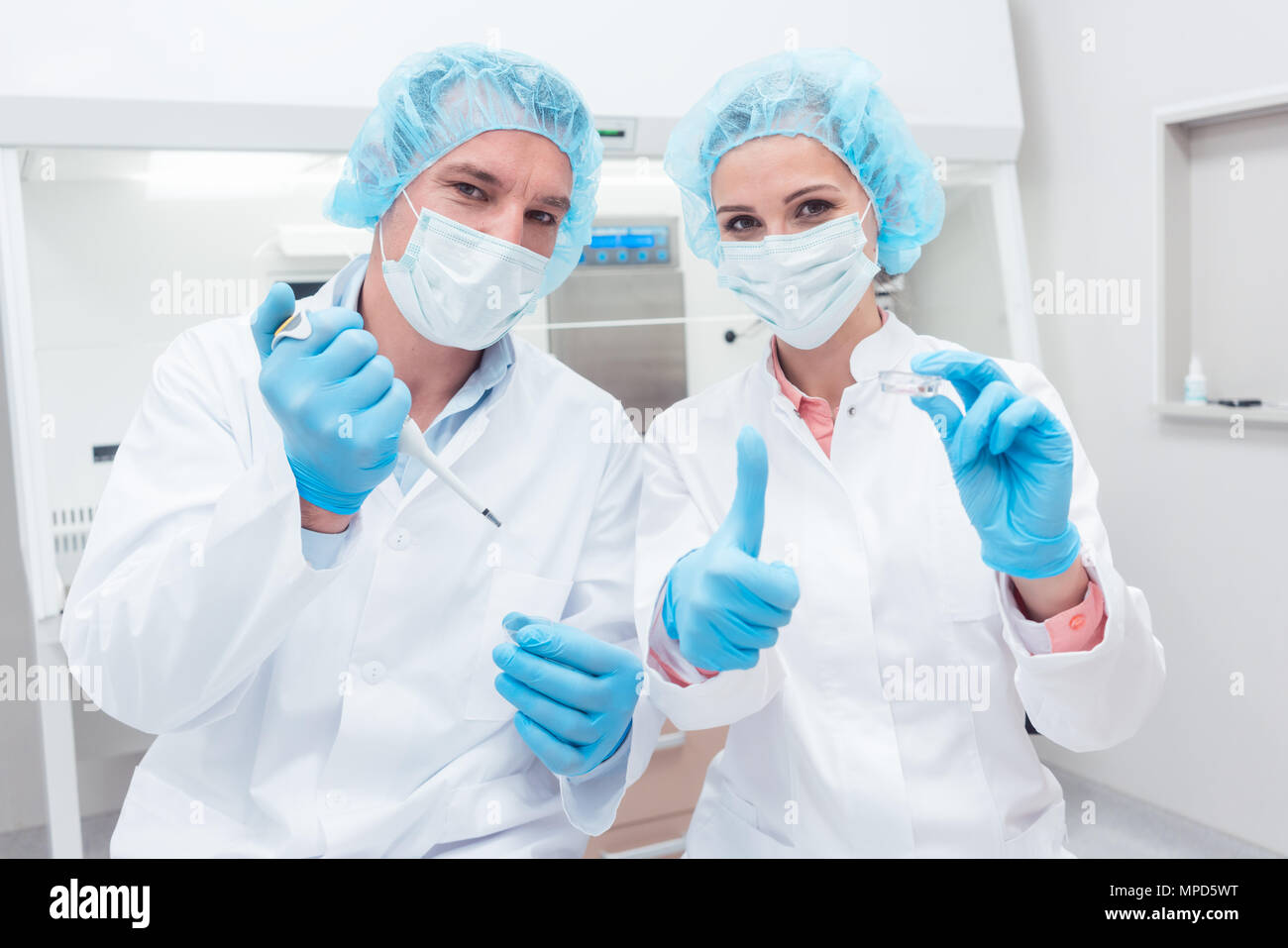 Two scientists with tools posing in the lab Stock Photo - Alamy