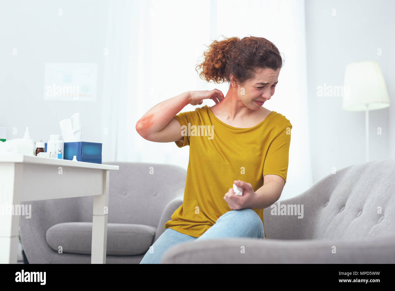 Young woman suffering from a neck sprain Stock Photo