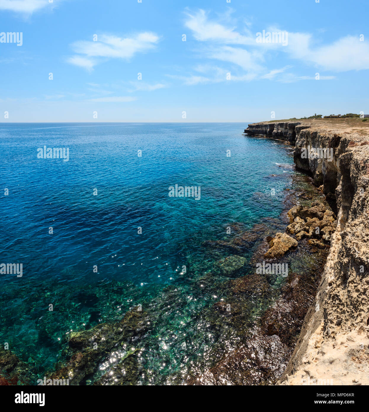 Picturesque seascape with white rocky cliffs, caves, sea bay at Grotta della poesia, Roca Vecchia, Salento Adriatic sea coast, Puglia, Italy. Two shot Stock Photo