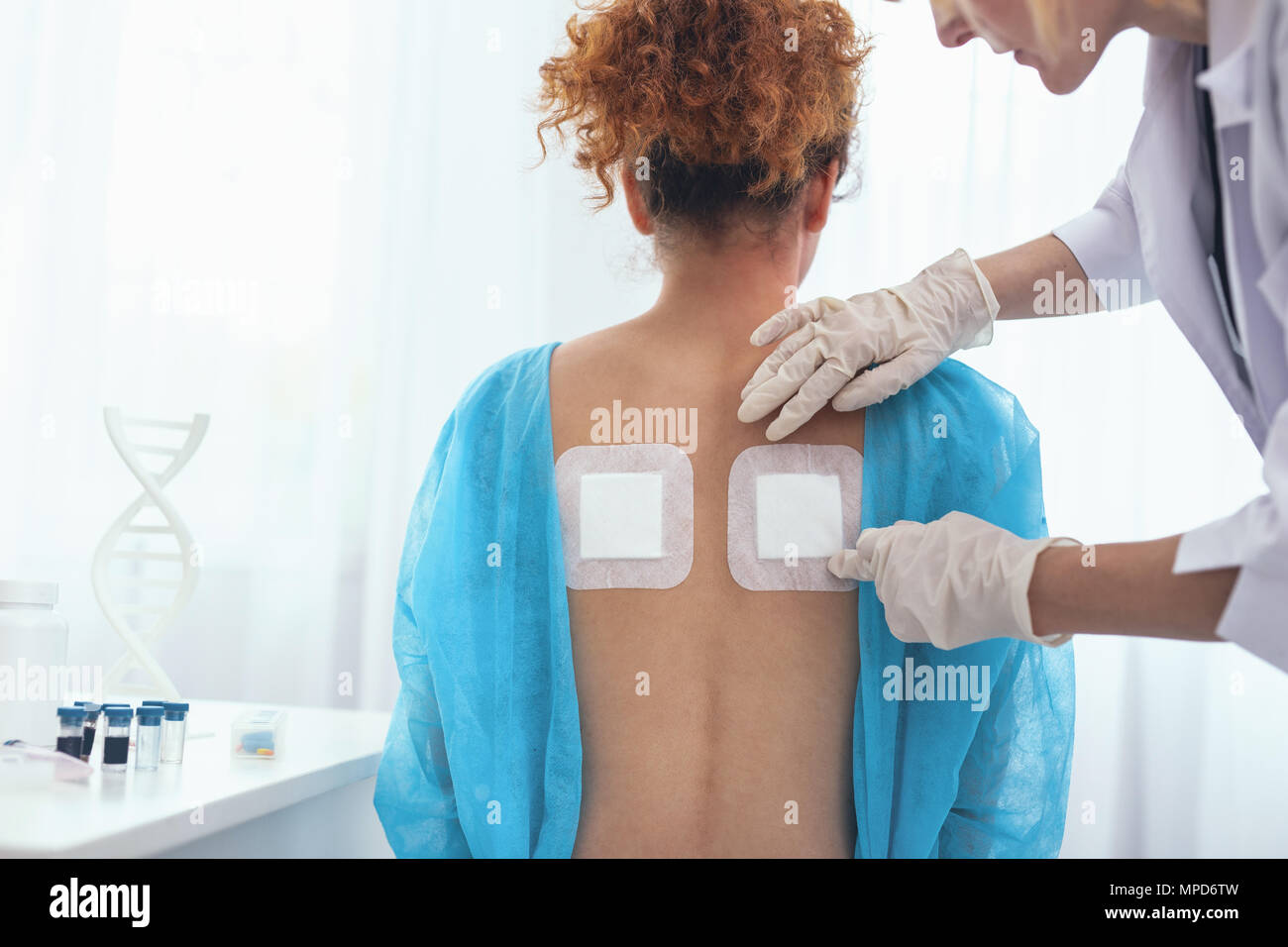 Young lady being given orthopaedic attention Stock Photo