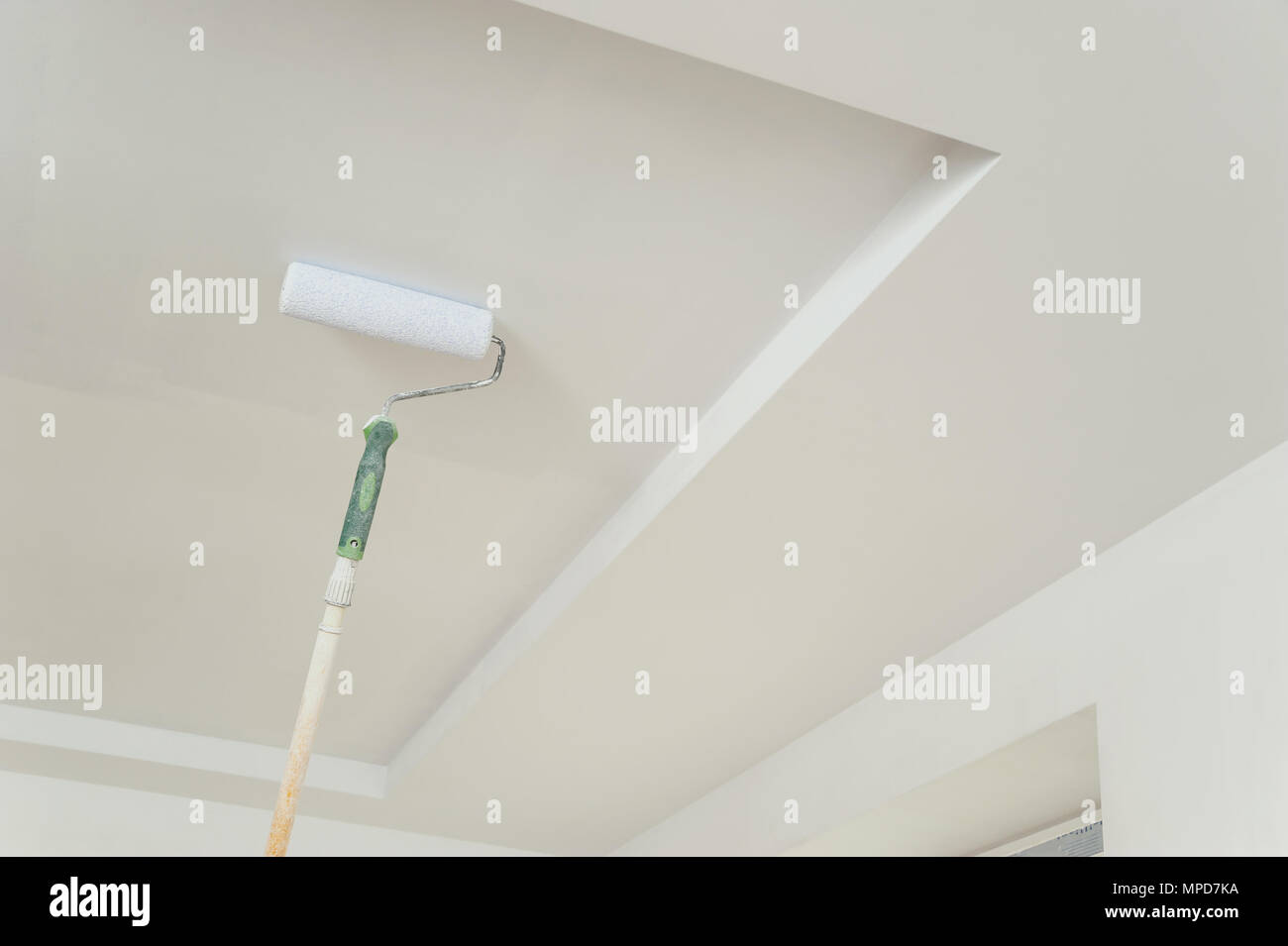 Painting The Ceiling And Walls Roller Touching The Surface And