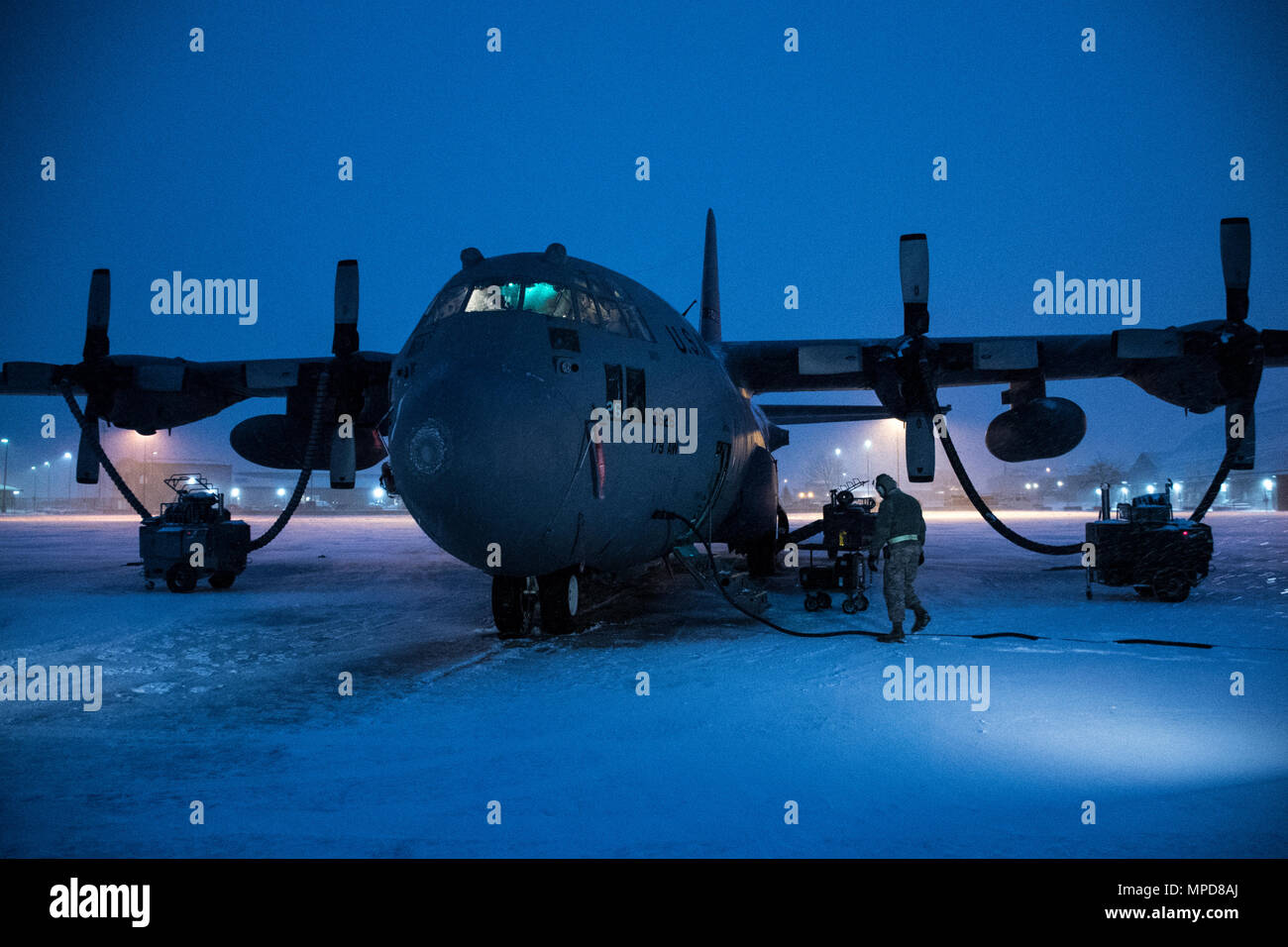 179th Airlift Wing Maintenance members prep the fleet of C-130H Hercules as a blanket of snow descends on them Feb. 9, 2017, at the 179th Airlift Wing, Mansfield, Ohio.  The 179th Airlift Wing is always on mission to be the first choice to respond to community, state and federal missions with a trusted team of highly qualified Airmen. (U.S. Air National Guard photo by 1st Lt. Paul Stennett/Released) Stock Photo