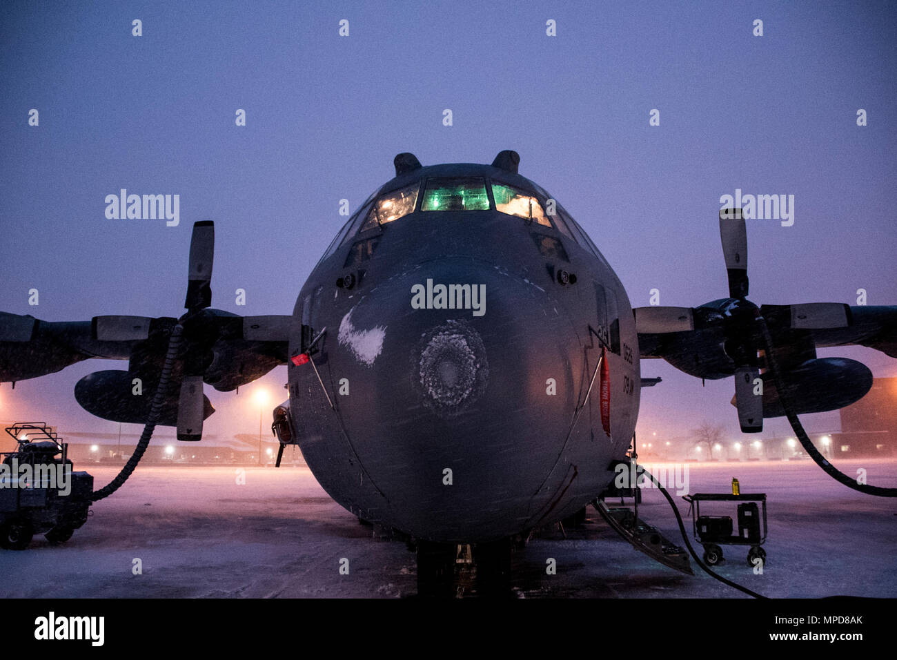 179th Airlift Wing Maintenance members prep the fleet of C-130H Hercules as a blanket of snow descends on them Feb. 9, 2017, at the 179th Airlift Wing, Mansfield, Ohio.  The 179th Airlift Wing is always on mission to be the first choice to respond to community, state and federal missions with a trusted team of highly qualified Airmen. (U.S. Air National Guard photo by 1st Lt. Paul Stennett/Released) Stock Photo