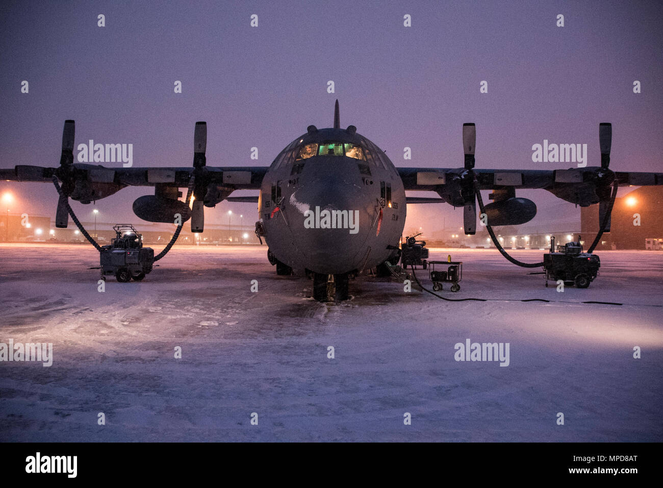 179th Airlift Wing Maintenance members prep the fleet of C-130H Hercules as a blanket of snow descends on them Feb. 9, 2017, at the 179th Airlift Wing, Mansfield, Ohio.  The 179th Airlift Wing is always on mission to be the first choice to respond to community, state and federal missions with a trusted team of highly qualified Airmen. (U.S. Air National Guard photo by 1st Lt. Paul Stennett/Released) Stock Photo