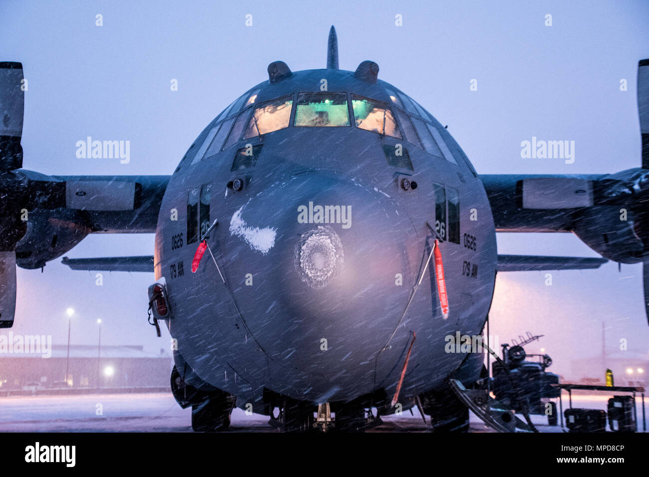 179th Airlift Wing Maintenance members prep the fleet of C-130H Hercules as a blanket of snow descends on them Feb. 9, 2017, at the 179th Airlift Wing, Mansfield, Ohio.  The 179th Airlift Wing is always on mission to be the first choice to respond to community, state and federal missions with a trusted team of highly qualified Airmen. (U.S. Air National Guard photo by 1st Lt. Paul Stennett/Released) Stock Photo