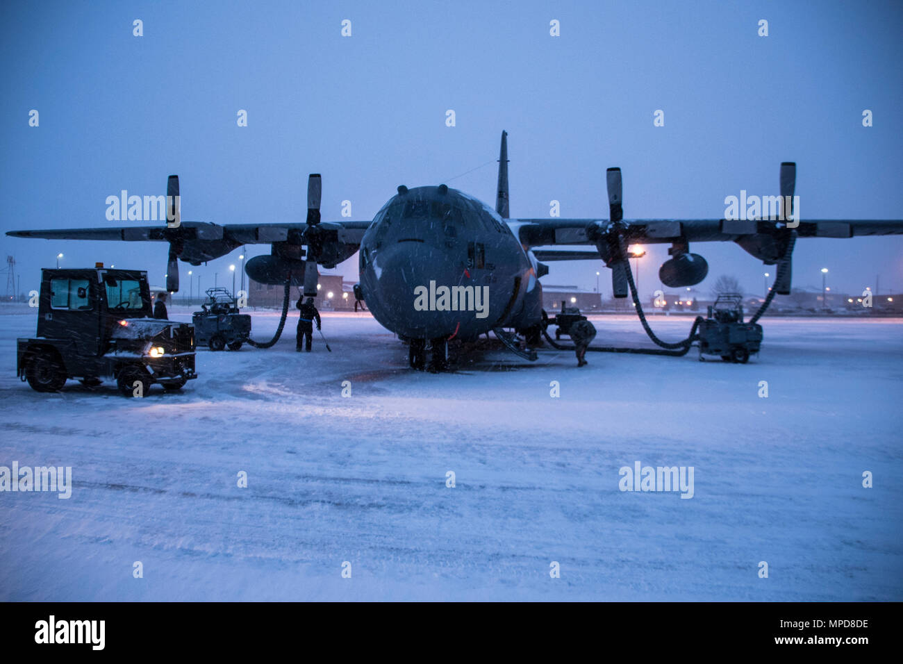 179th Airlift Wing Maintenance members prep the fleet of C-130H Hercules as a blanket of snow descends on them Feb. 9, 2017, at the 179th Airlift Wing, Mansfield, Ohio.  The 179th Airlift Wing is always on mission to be the first choice to respond to community, state and federal missions with a trusted team of highly qualified Airmen. (U.S. Air National Guard photo by 1st Lt. Paul Stennett/Released) Stock Photo