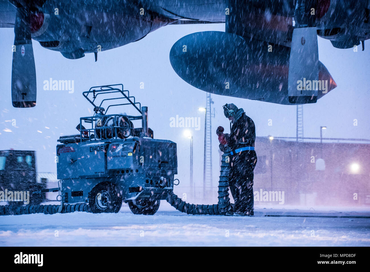 179th Airlift Wing Maintenance members prep the fleet of C-130H Hercules as a blanket of snow descends on them Feb. 9, 2017, at the 179th Airlift Wing, Mansfield, Ohio.  The 179th Airlift Wing is always on mission to be the first choice to respond to community, state and federal missions with a trusted team of highly qualified Airmen. (U.S. Air National Guard photo by 1st Lt. Paul Stennett/Released) Stock Photo