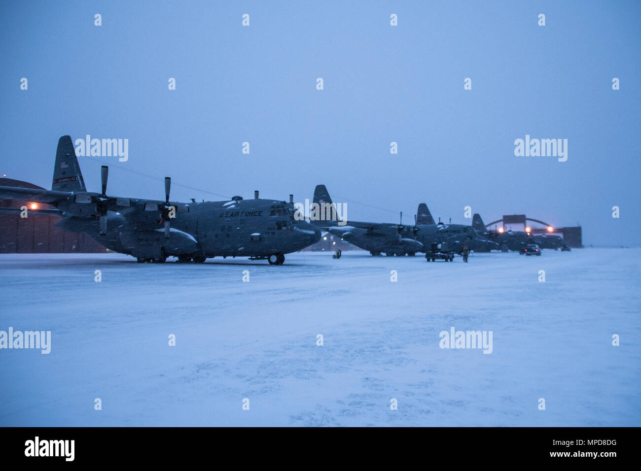 179th Airlift Wing Maintenance members prep the fleet of C-130H Hercules as a blanket of snow decends on them Feb. 9, 2017, at the 179th Airlift Wing, Mansfield, Ohio.  The 179th Airlift Wing is always on mission to be the first choice to respond to community, state and federal missions with a trusted team of highly qualified Airmen. (U.S. Air National Guard photo by 1st Lt. Paul Stennett/Released) Stock Photo