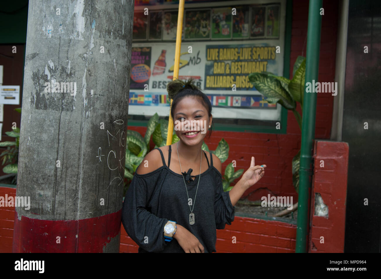 A girl standing outside the LA Cafe, Manila Stock Photo - Alamy