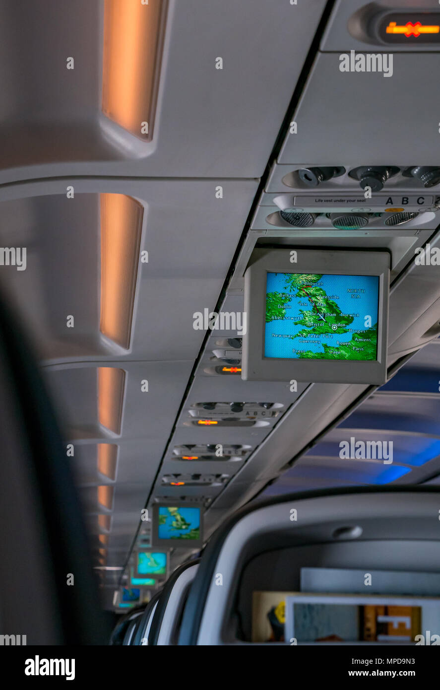 View from British Airways airline seat down plane cabin with video display tracking airplane journey from Edinburgh to London Heathrow Stock Photo