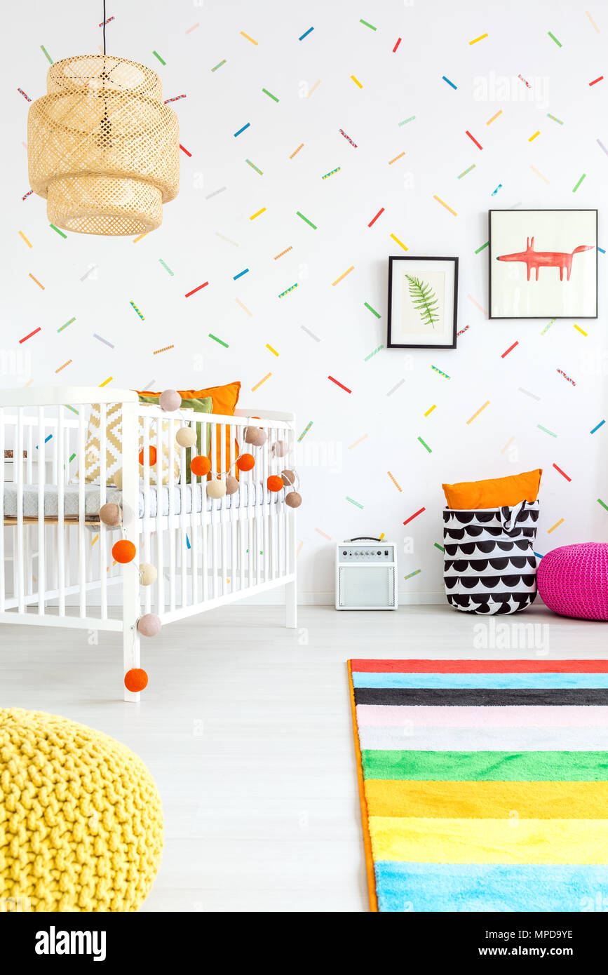 Baby room with colorful wall decor and white cot Stock Photo - Alamy