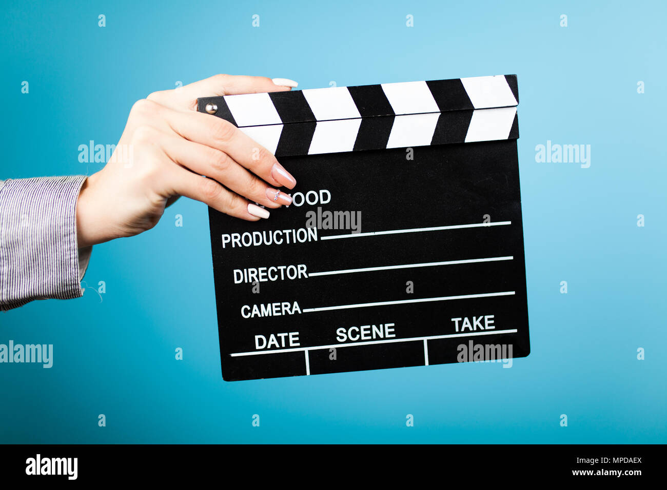 Female hands holding a clapperboard Stock Photo