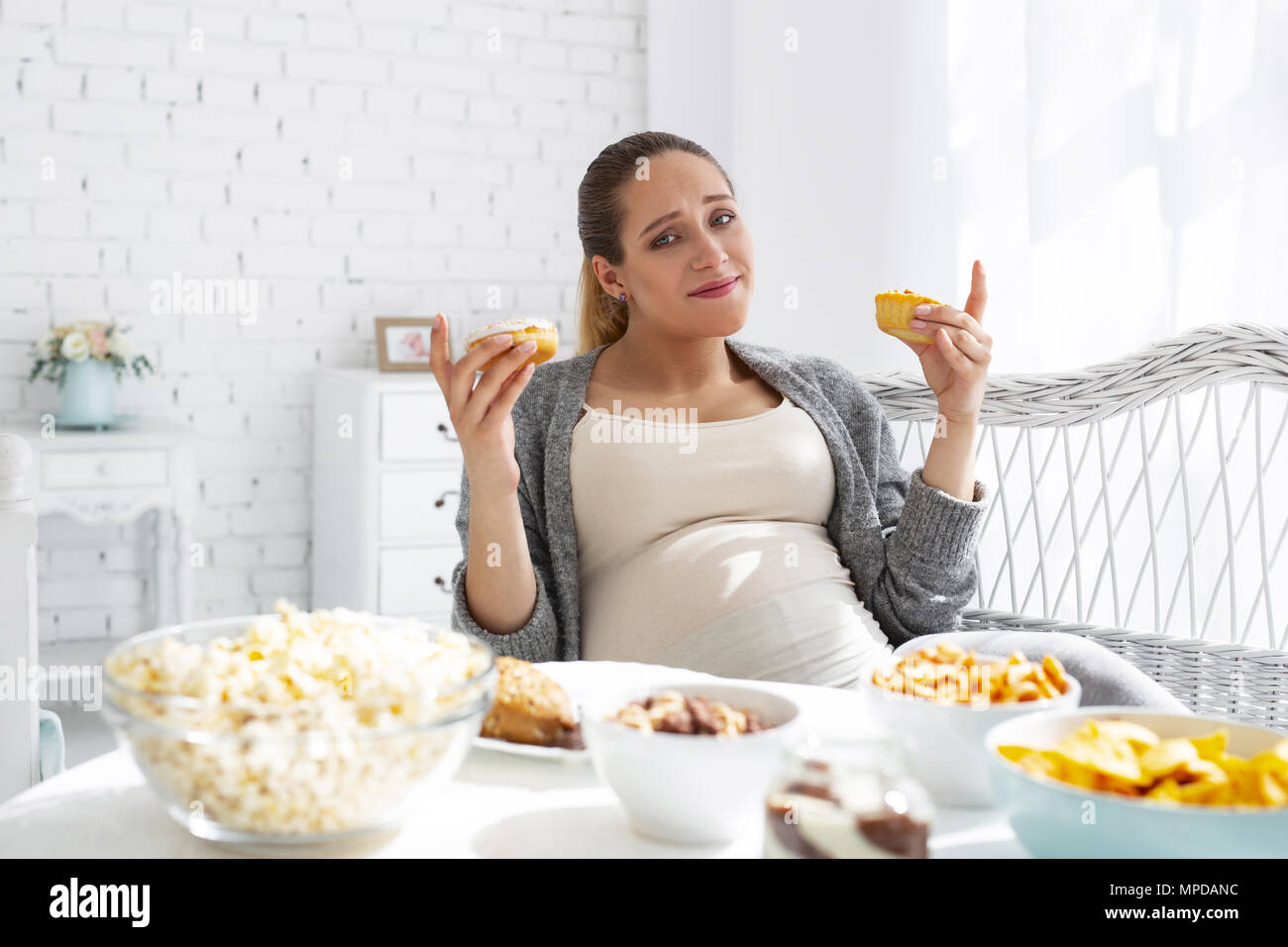 Pleasant pregnant woman opting French pastry Stock Photo Alamy
