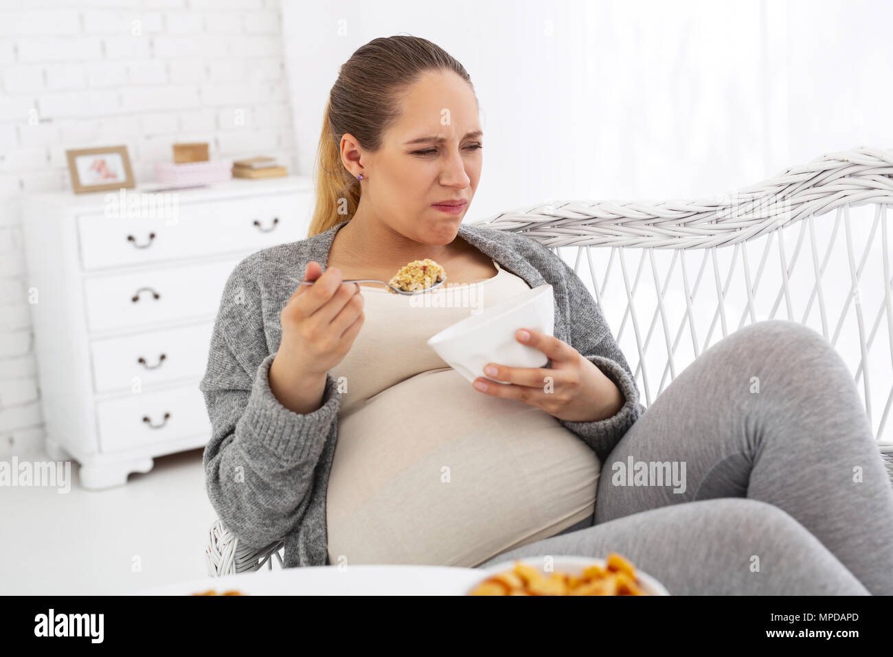 Mad pregnant woman eating granola Stock Photo Alamy