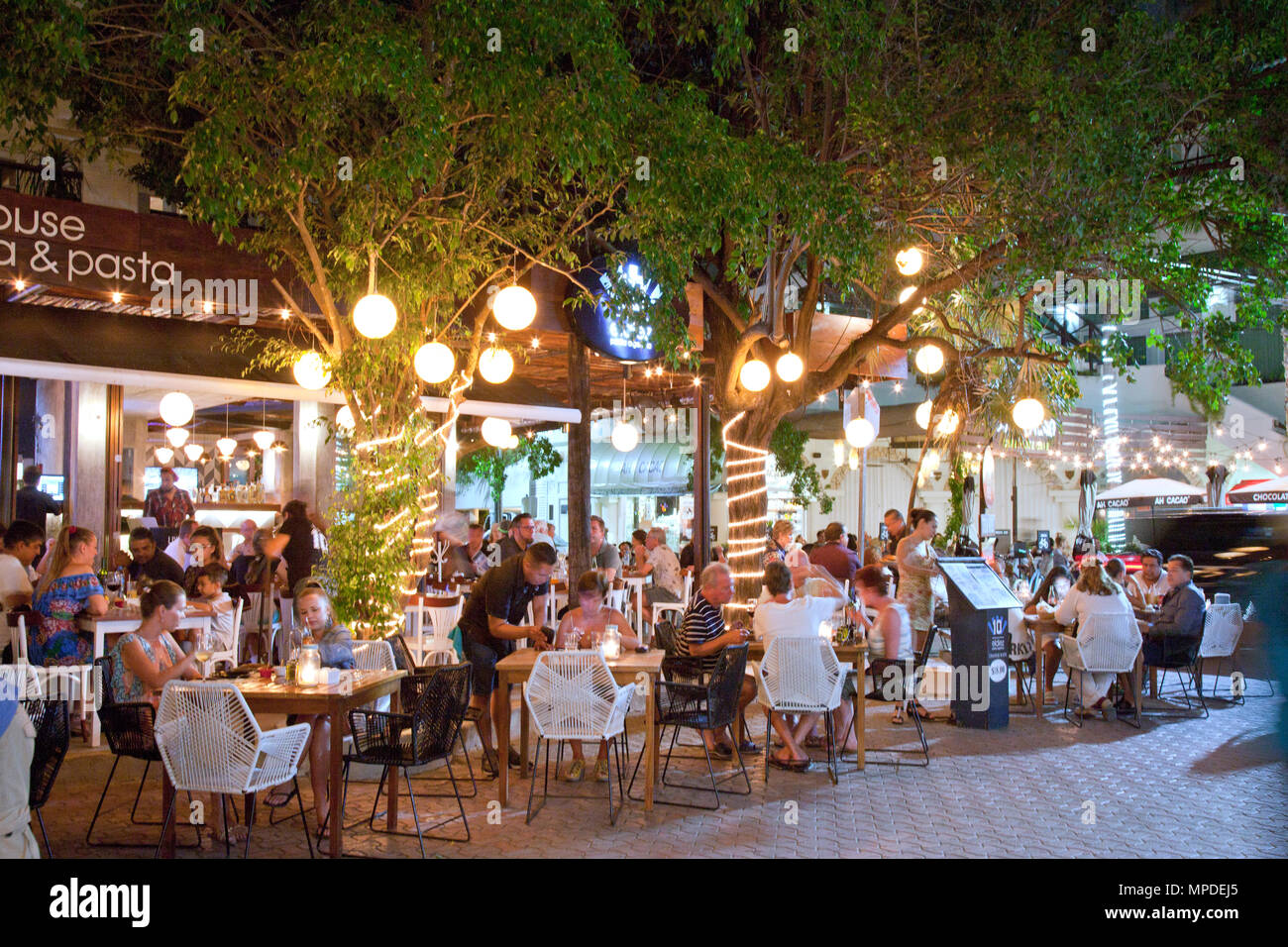 Night Along 5th Avenida, Playa Del Carmen, Quintana Roo, Mexico.  Numerous open-air eateries draw crowds when the weather is nice. Stock Photo