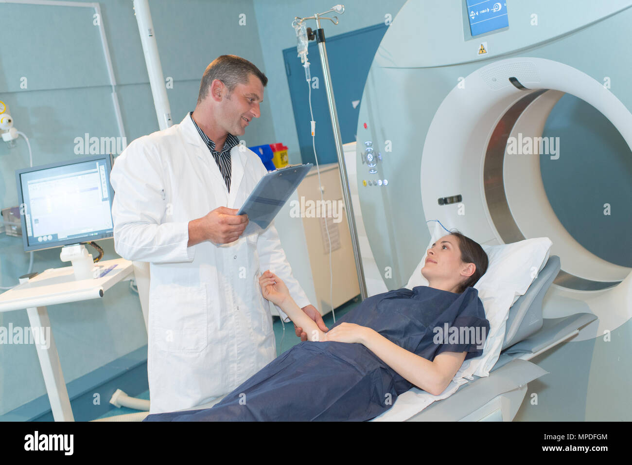 female patient looking at radiologist preparing her for mri scan Stock ...