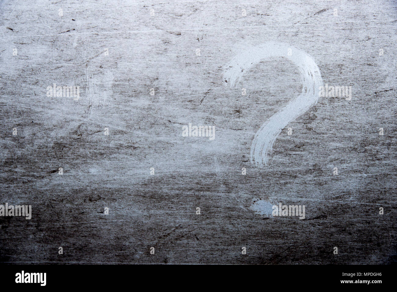 question mark is drawn on scratched dirty background Stock Photo