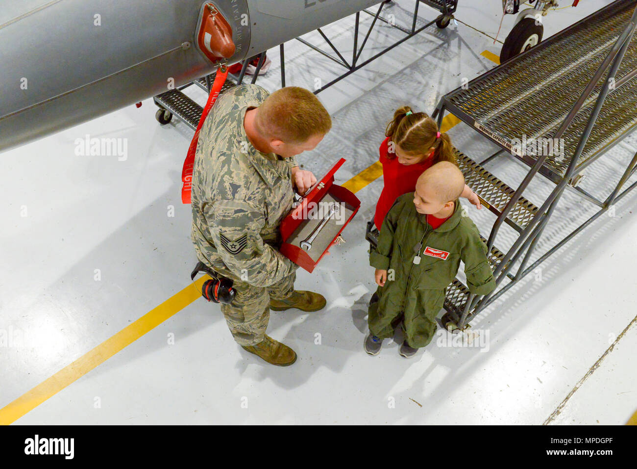 Technical Sgt. Brian Massey, 138th Aircraft Maintenance Squadron, presents Sam “Burner” Bilby, 138th Fighter Wing’s newest Pilot for a Day, with his very own tool box and engraved wrench during a personalized tour held here April 10, 2017.  The Pilot for a Day is a program allowing children with potentially life threatening illnesses a chance to experience a day in the life of an F-16 fighter pilot. Stock Photo