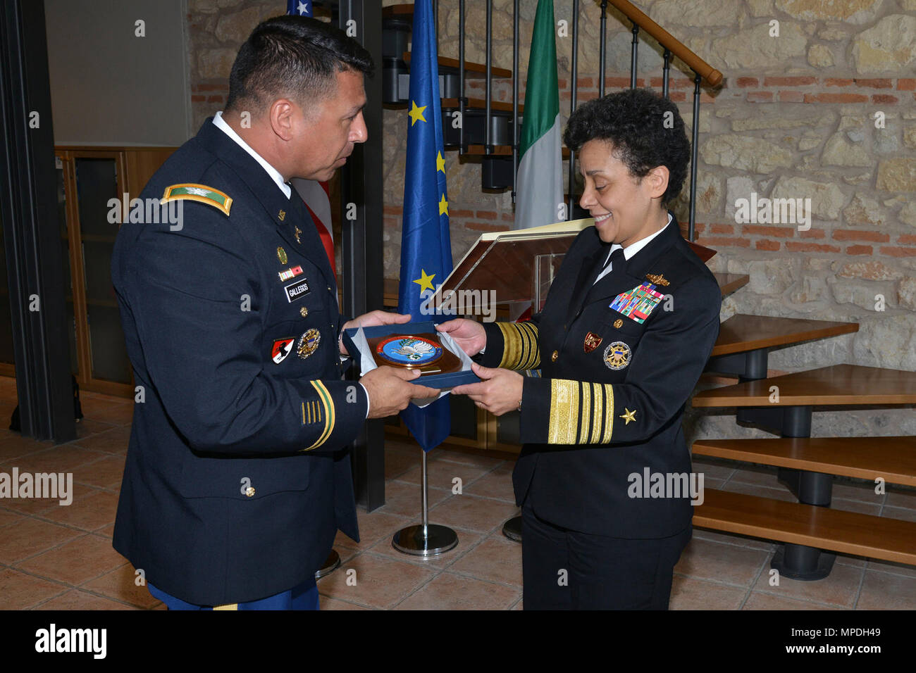 U.S. Army Col. Darius S. Gallegos, CoESPU deputy director (left), presents Carabinieri CoESPU crest to Admiral Michelle Howard, NATO JFC-Naples Commander, during the visit at the Center of Excellence for Stability Police Units (CoESPU) Vicenza, April 10, 2017. Stock Photo