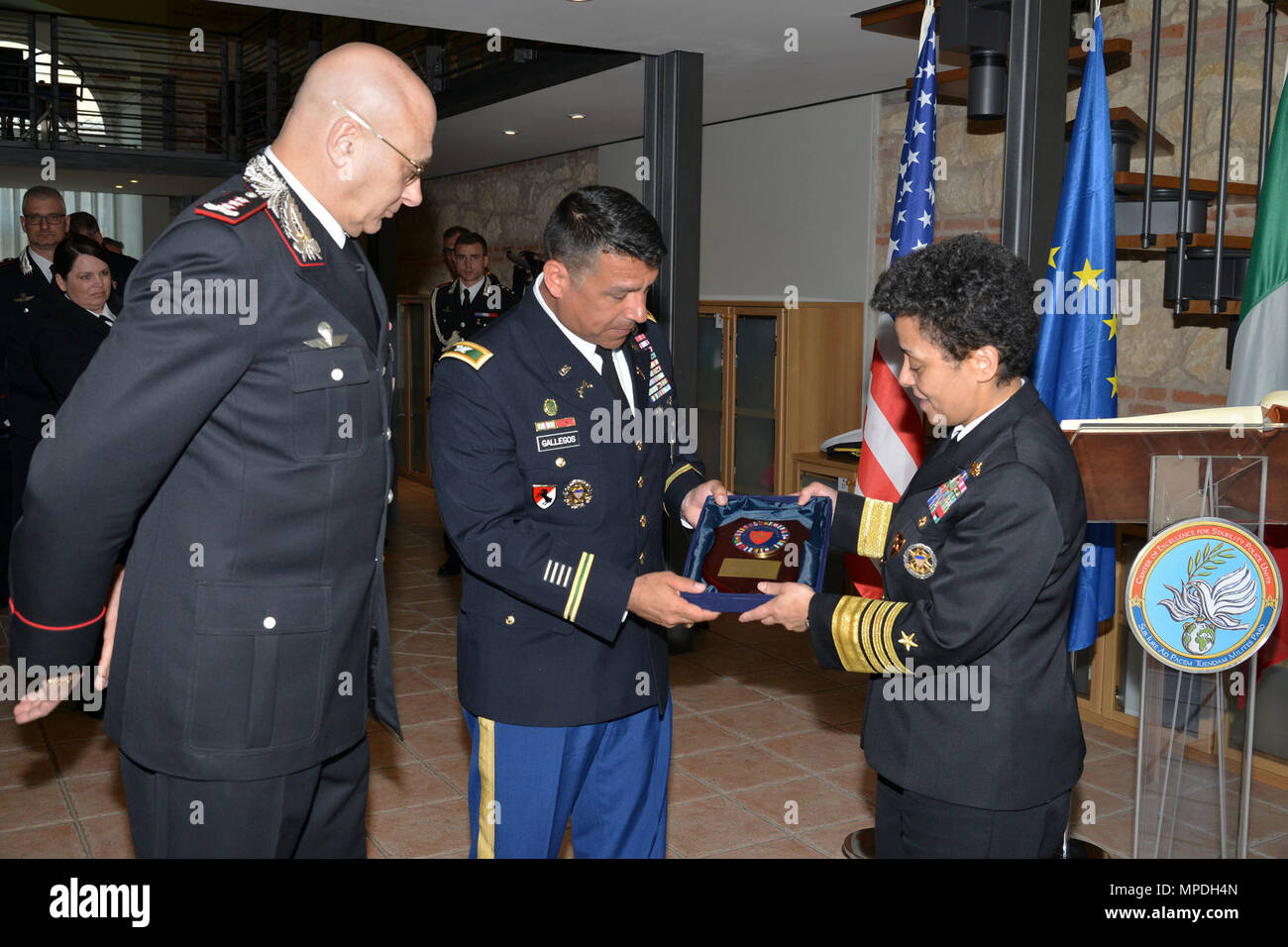 U.S. Army Col. Darius S. Gallegos, CoESPU deputy director (center), Italian Carabinieri Lt. Gen Vincenzo Coppola (left), deputy commander of the Carabinieri Corps receive gift from Admiral Michelle Howard (right), NATO JFC-Naples Commander during the visit at the Center of Excellence for Stability Police Units (CoESPU) Vicenza, April 10, 2017. Stock Photo