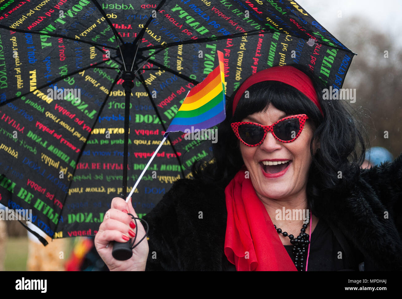A woman waves a rainbow flag during fasching, a festival held across Europe, in the city of Ramstein, Germany, Feb. 28, 2017. The festival has been recognized and celebrated since the 13th century. Written records show the first carnival was held in 1341 in Köln, Germany. (U.S. Air Force photo by Senior Airman Lane T. Plummer) Stock Photo