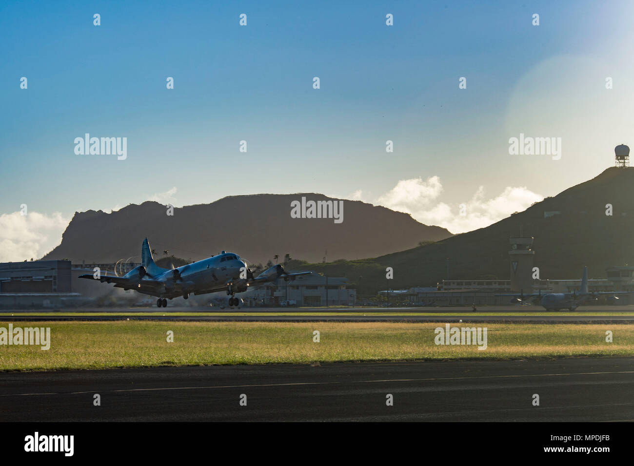 170303-N-YW024-061 KANEOHE BAY, HAWAII (Mar. 3, 2017) A P-3 Orion, assigned to Patrol Squadron Nine (VP-9) Golden Eagles, takes off during a command disestablishment at Marine Corps Base Hawaii. The VP-9  squadron was leaving for a scheduled deployment, to be followed by a homeport shift to Naval Air Station Whidbey Island in Washington. The P-3 Orion is a four-engine turboprop anti-submarine and maritime surveillance aircraft developed by the U.S. Navy in the 1960s. (U.S. Navy photo by Mass Communication Specialist 2nd Class Katarzyna Kobiljak) Stock Photo