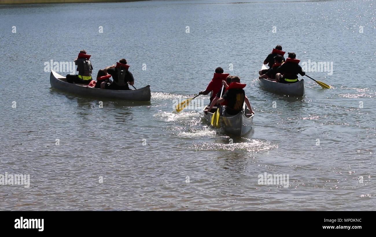 Soldiers canoe across a lake at the Spartan Challenge at Camp Shelby