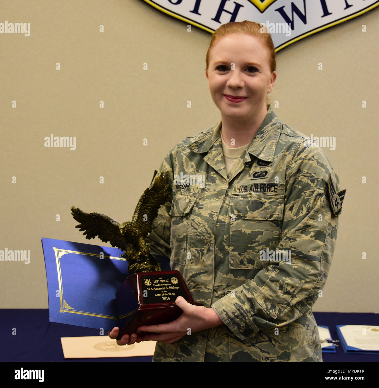 Senior Airman Amanda S. Bishop, newly promoted to staff sergeant, displays her Airman of the Year award on March 4, 2017 at Berry Field Air National Guard Base, Nashville, Tennessee. Bishop won the award for her outstanding work in the finance office. (U.S. Air National Guard photo by Senior Airman Anthony Agosti) Stock Photo