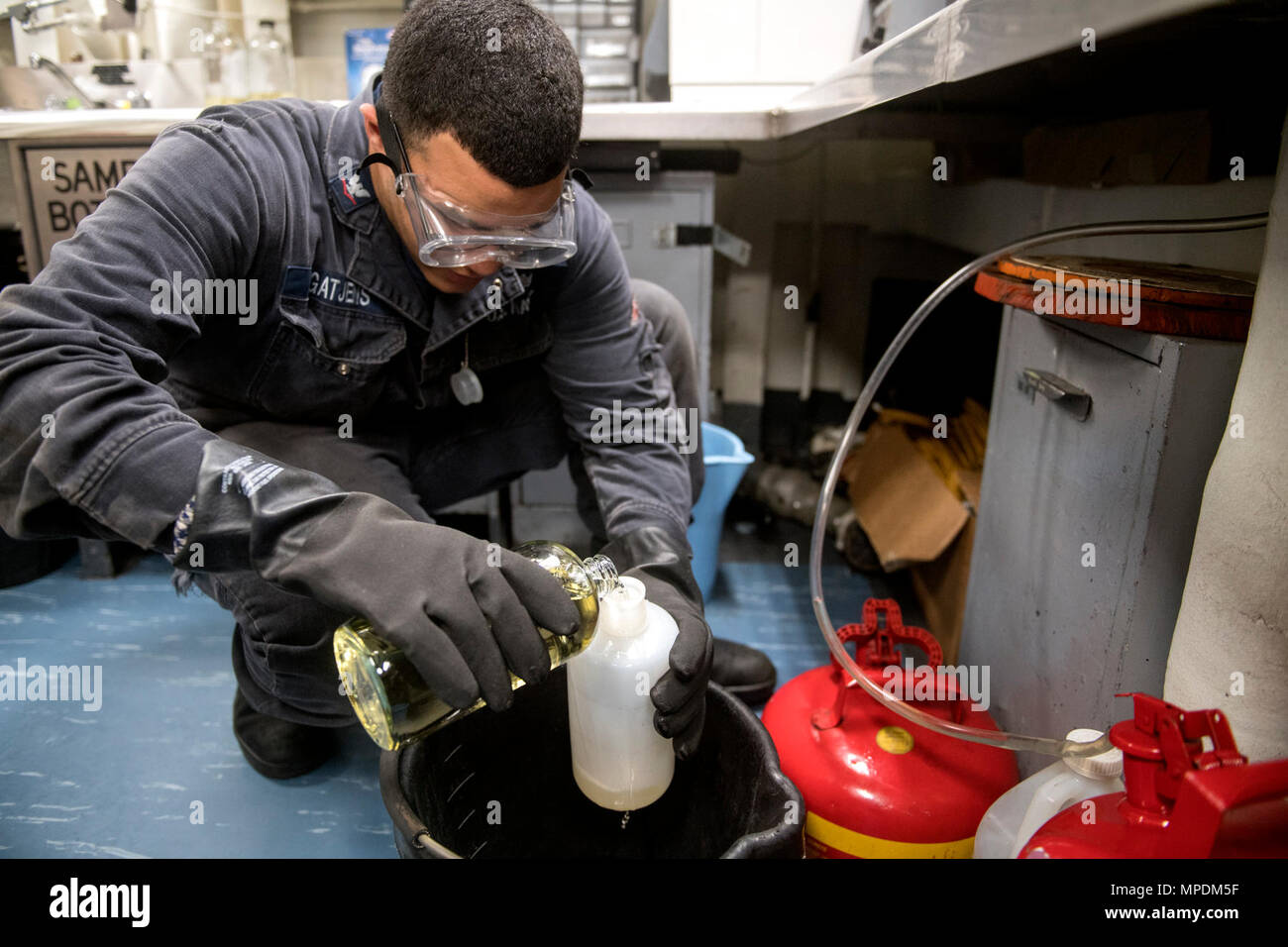 Aboard USS Lake Champlain (CG 57), crew conduct a contaminated fuel ...