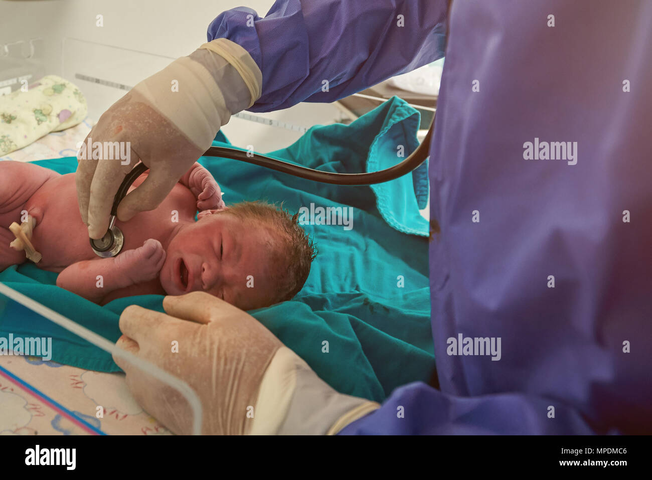 Nurse checking health of newborn baby with stethoscope Stock Photo