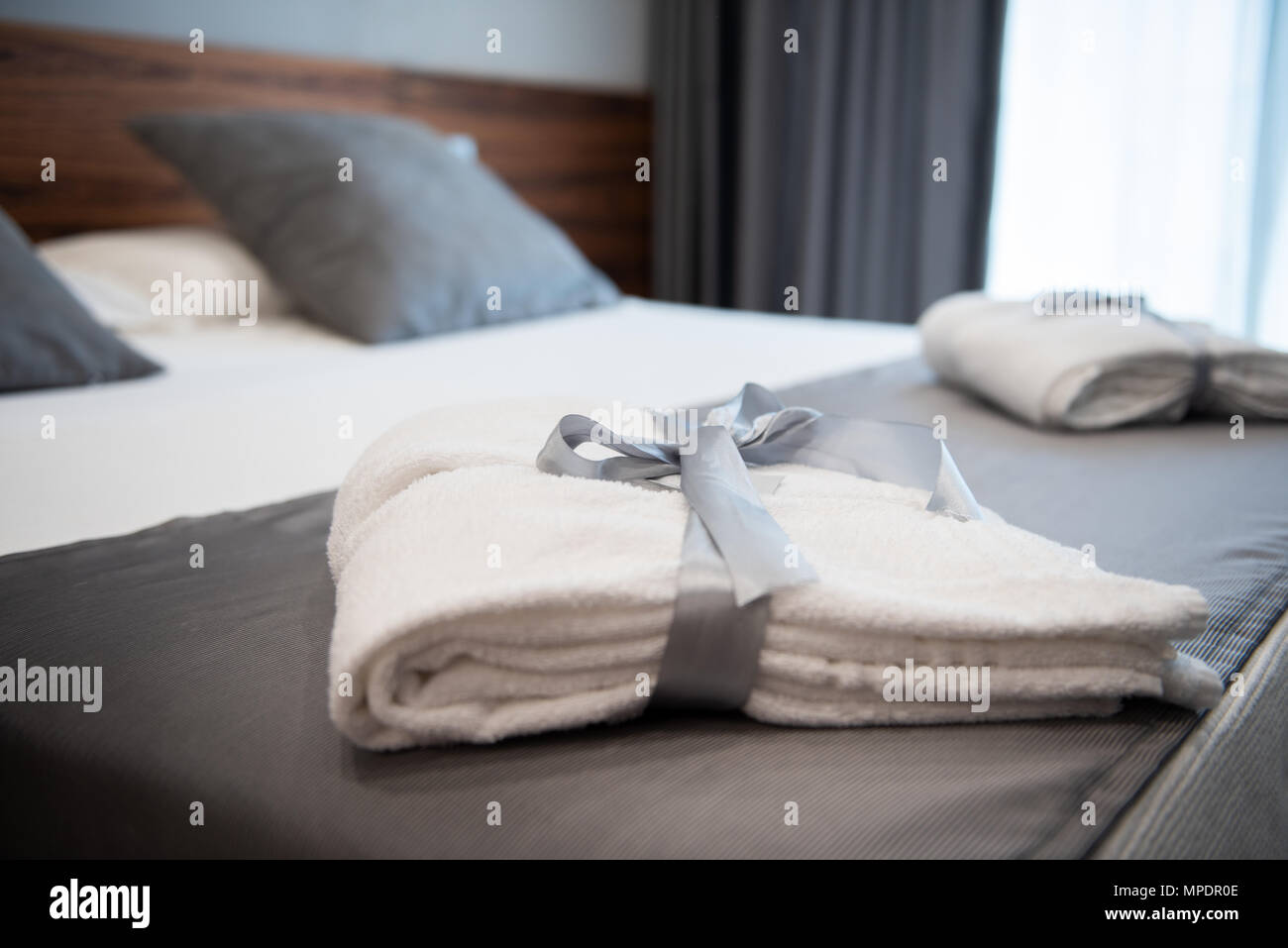 Bathrobe on bed in hotel room Stock Photo Alamy
