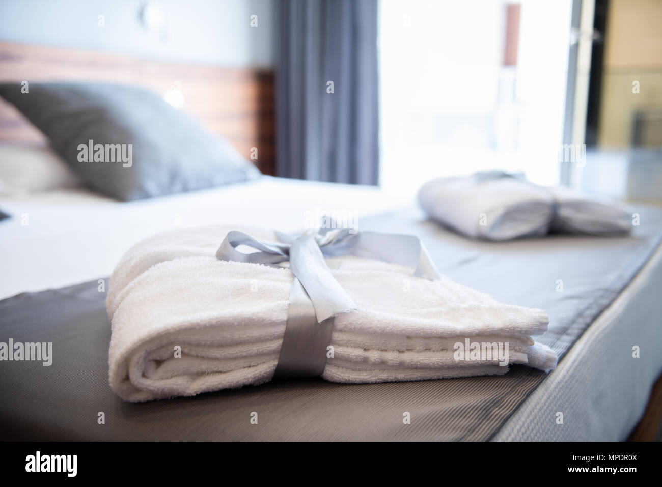 Bathrobe on bed in hotel room Stock Photo Alamy
