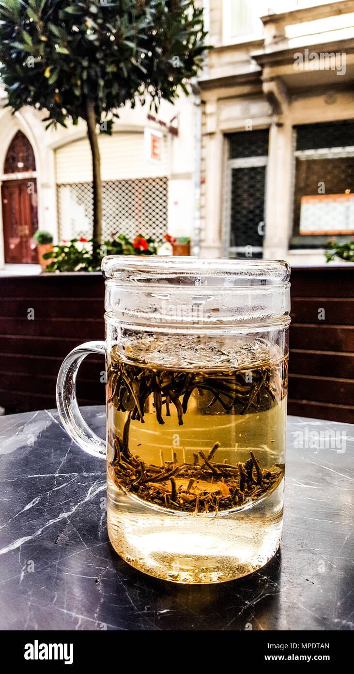 White Earl Grey Tea in glass at cafe near the street. Beverage Concept