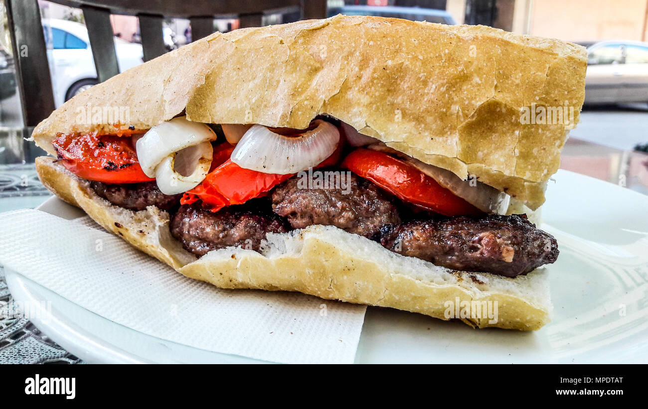 Turkish Kofte Ekmek / Meatball Sandwich with tomatoes, onion and green