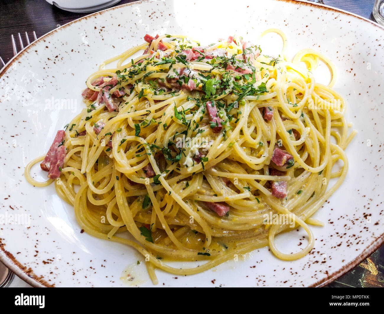 Spaghetti Carbonara with bacon and creme at restaurant shot with natural light. italian food