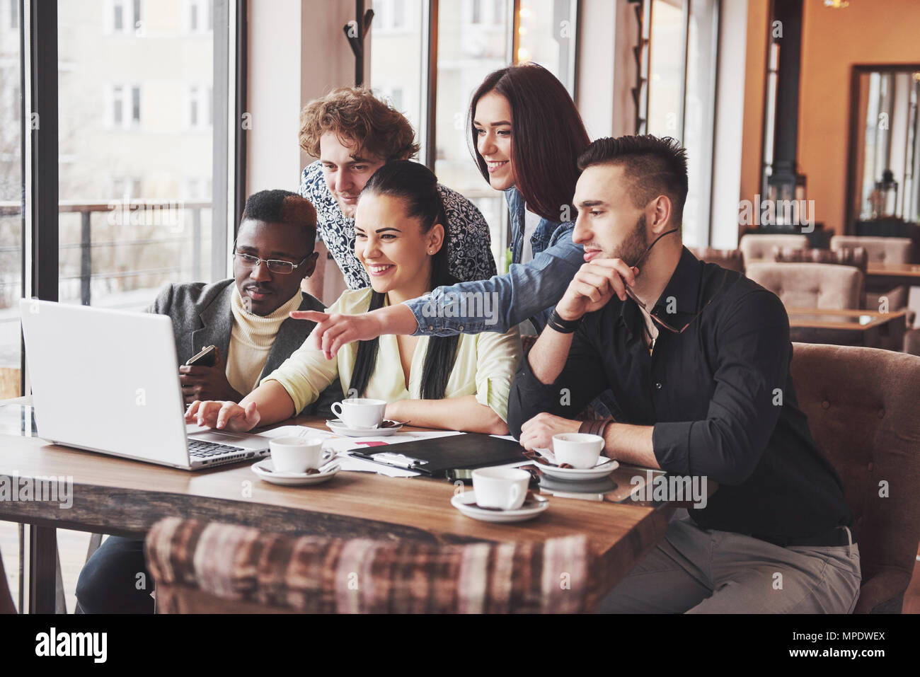 Group portrait of Cheerful old friends communicate with each other, friend posing on cafe, Urban style people having fun, Concepts about youth togetherness lifestyle. Wifi connected Stock Photo